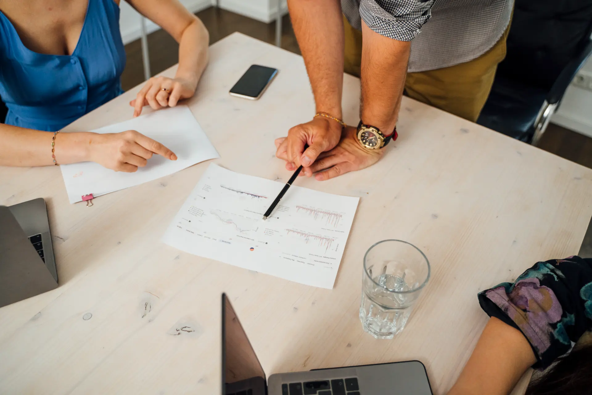 Auswertung eines Social-Media-Analytics-Reports auf Papier am Besprechungstisch